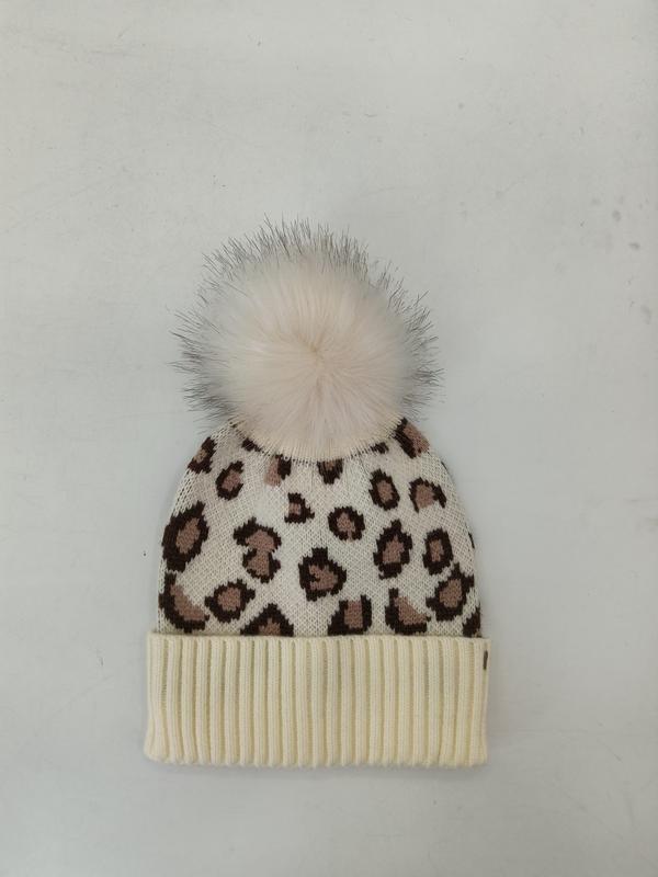 Cream knit beanie with brown leopard print pattern and fluffy white faux fur pom-pom on top, ribbed cuff - wholesale price for Europe buyers