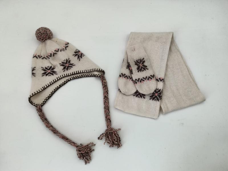 Cream knit winter set with Nordic snowflake pattern including earflap pom-pom hat with braided tassels, mittens, and scarf - email us get price list now