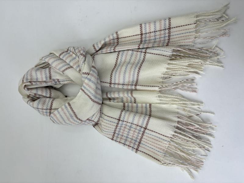 Cream woven plaid scarf with blue, pink, and brown stripes, twisted fringe ends, laid flat on white background - custom Pantone color matching