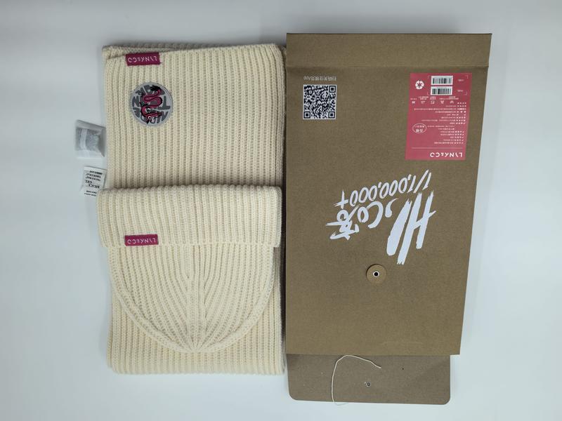 Cream ribbed knit beanie hat and matching scarf set with burgundy logo patch displayed beside kraft paper gift box packaging - custom packaging design free