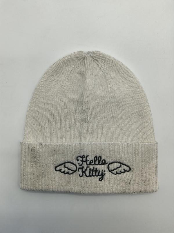 Cream ribbed knit beanie hat with Hello Kitty angel wings embroidery on folded cuff, laid flat on white background - bulk order 20-day delivery