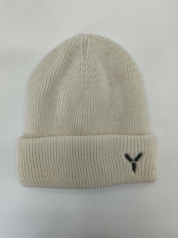 Cream ribbed knit beanie hat with folded cuff and small black embroidered Y logo, laid flat on white background - BSCI + Oeko-Tex + GRS certified