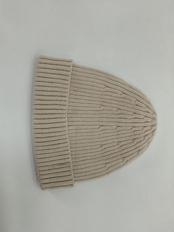 Cream ribbed knit beanie hat with folded cuff laid flat on white background, showing fine rib texture - BSCI audit passed supplier