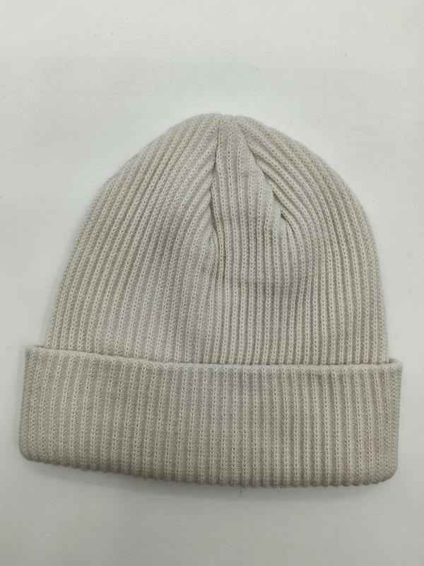 Cream ribbed knit cuffed beanie hat laid flat on white background, showing fine rib texture and folded brim - free sample within 7 days