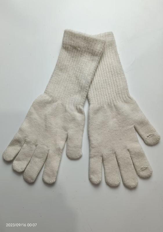 Pair of cream off-white ribbed knit full-finger gloves laid flat on white background, showing both palms - tiered pricing available ask quote