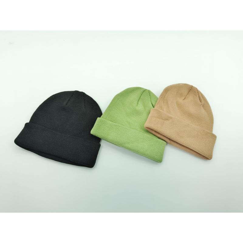 Three plain cuffed knit beanies laid flat in black, sage green, and tan on a white background - Oeko-Tex Standard 100 certified