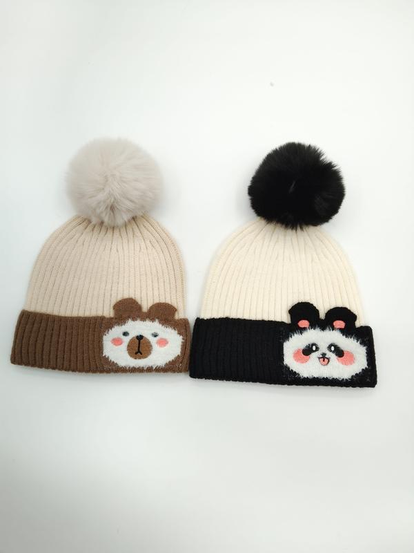 Two knit beanies with pom poms: brown bear design on tan hat and panda design on black and cream hat - sample order 10pcs available