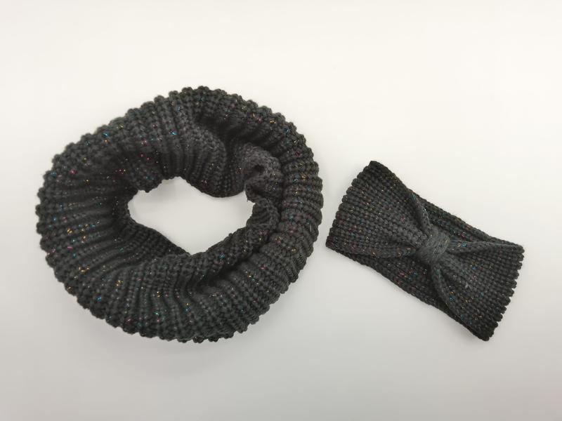 Dark gray chunky knit infinity scarf coiled in circle beside matching bow headband with colorful metallic lurex threading - custom Pantone color matching