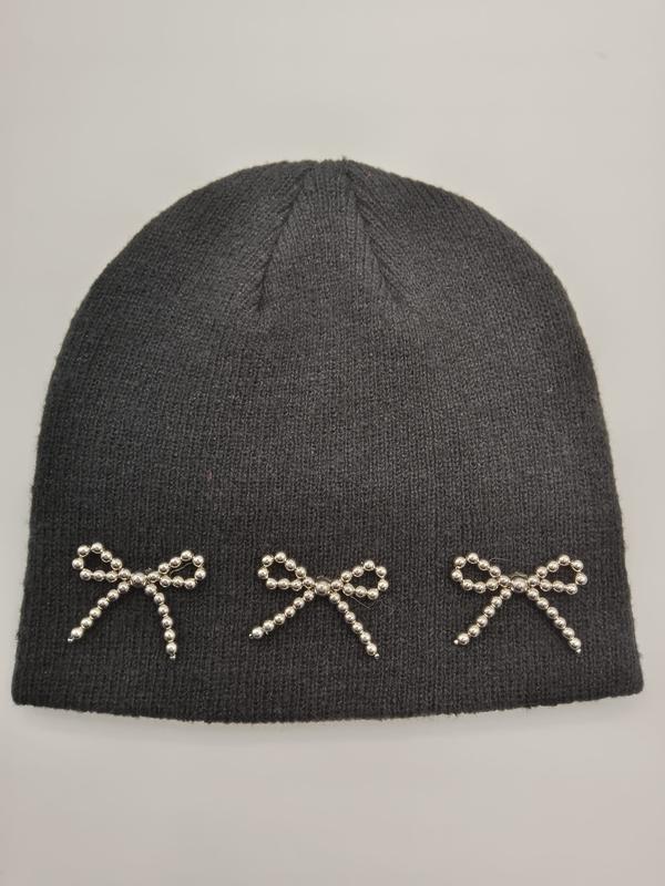 Dark charcoal ribbed knit winter beanie hat featuring three decorative silver beaded bow appliques along the brim - retail buyer inquiry welcome