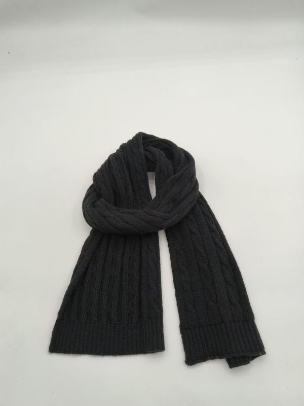Dark charcoal grey cable knit scarf loosely coiled on white background, showing ribbed texture and two flat ends - air shipping 5-7 days arrival