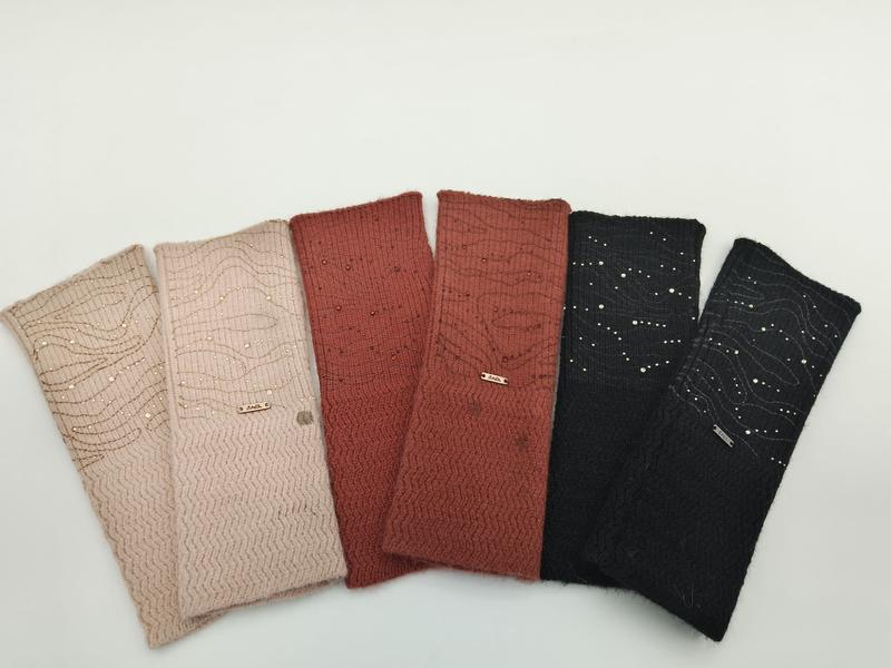 Six knit headbands fanned out in pink, dusty rose, rust, terracotta, charcoal and black with sequin and wave embroidery details - custom Pantone color matching