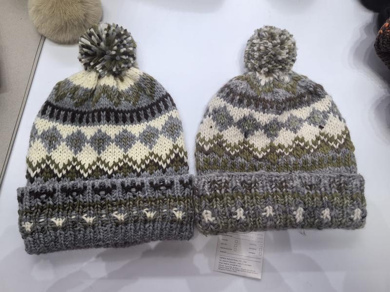 Two chunky knit Fair Isle pom pom beanies in grey, olive green and cream with folded cuff, displayed side by side - bulk order 20-day delivery
