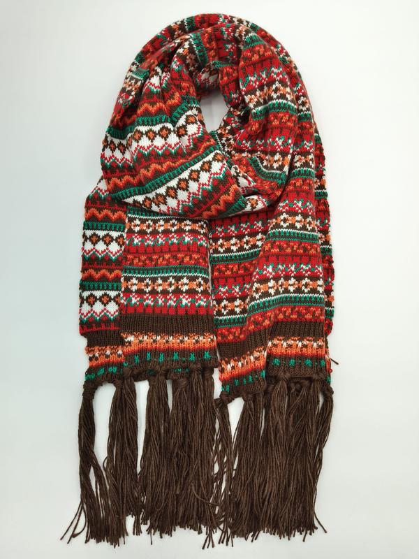 Coiled fair isle knit scarf in red, green, orange and white geometric pattern with long brown tassel fringe ends - sample order 10pcs available
