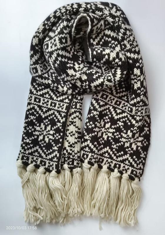 Black and cream Fair Isle patterned knit scarf with chunky tassel fringe ends, folded to display geometric snowflake design - factory direct price no middleman