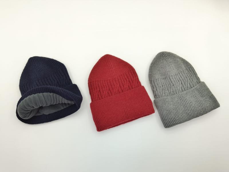 Three ribbed knit beanies in navy blue, red, and grey displayed on white background, navy hat showing grey fleece lining - factory direct price no middleman