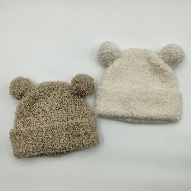 Two fuzzy knit baby beanies with bear ears and pom-poms in beige and cream colors on white background - MOQ 100pcs mixed colors OK