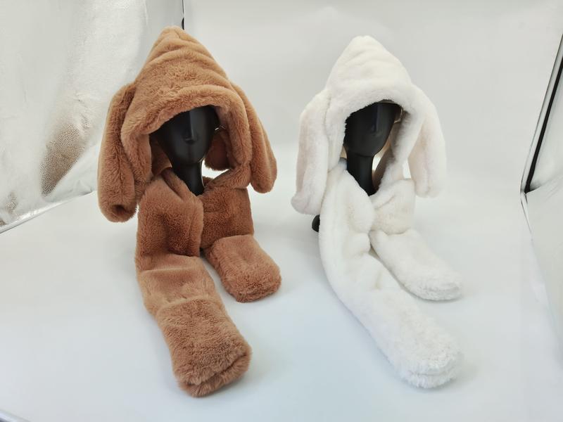 Two faux fur hooded scarf sets with long bunny ears on mannequins, one brown and one white, displayed on white surface - private label service available