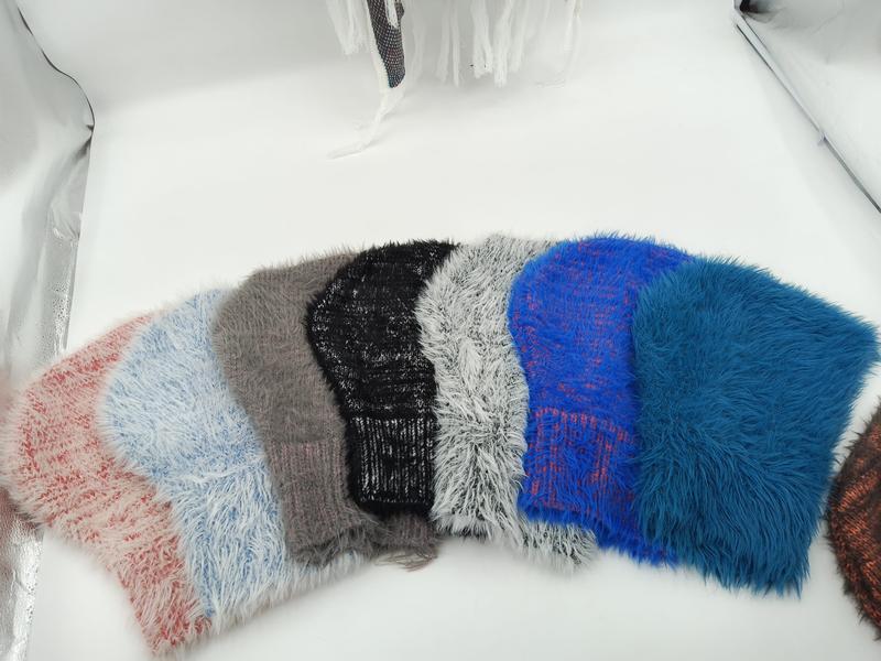 Six fluffy knit beanies in pink, blue, gray, black, white, and royal blue arranged in a fan display on white background - custom packaging design free