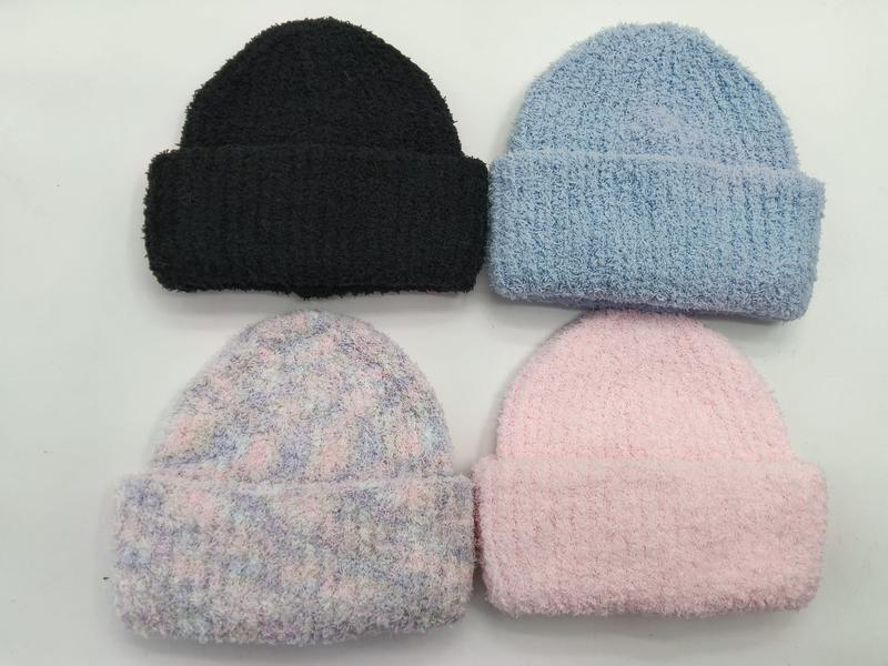 Four fluffy knit cuffed beanies in black, light blue, pastel tie-dye, and pink laid flat on white background - low MOQ 50pcs trial order