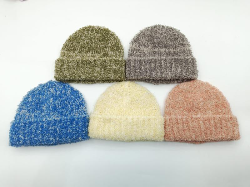 Five fuzzy bouclé knit beanie hats in olive green, gray, blue, cream, and dusty rose arranged on white background - gift shop wholesale supplier