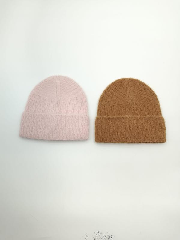 Two fluffy knit beanies laid flat on white surface, one in blush pink and one in camel brown, both with folded cuffs - email us get price list now