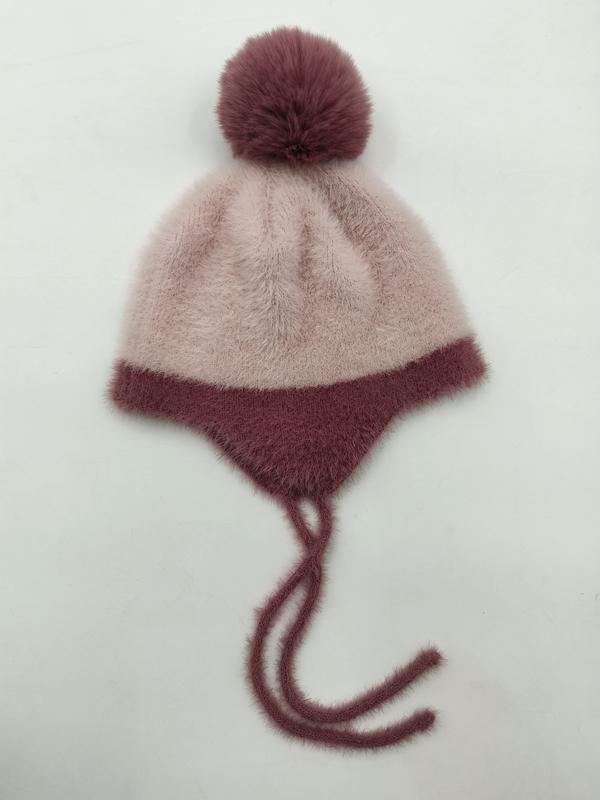 Dusty pink fuzzy knit earflap winter beanie hat with dark mauve pom-pom and tie strings laid flat - express production 15 days