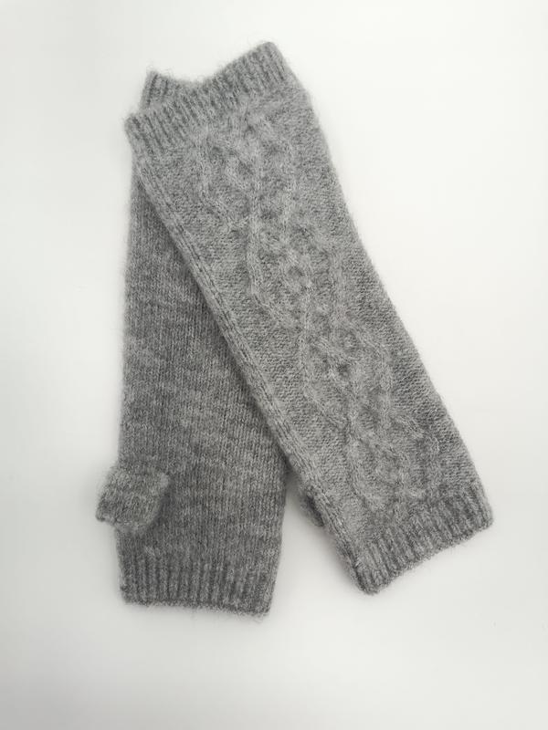 Pair of gray cable knit fingerless gloves with ribbed cuffs and thumb holes laid flat on white background - wholesale price for Middle East buyers