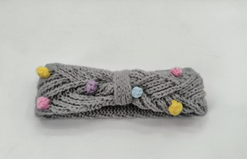 Gray cable knit headband with multicolor pom poms in yellow, pink, purple and blue, twisted bow center detail - request quote reply same day