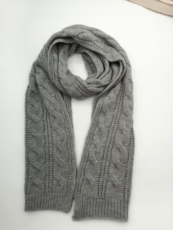 Gray cable knit scarf looped and laid flat on white surface showing braided texture and ribbed cuffs - BSCI audit passed supplier