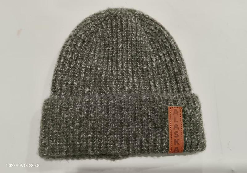 Gray marl ribbed knit cuffed beanie hat with brown leather Alaska patch label on folded brim - free sample within 7 days
