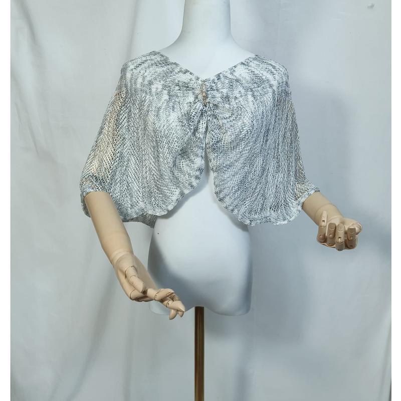 White mannequin wearing a sheer gray snakeskin print mesh capelet with a decorative brooch closure at the front neckline - retail buyer inquiry welcome - factory direct price no middleman