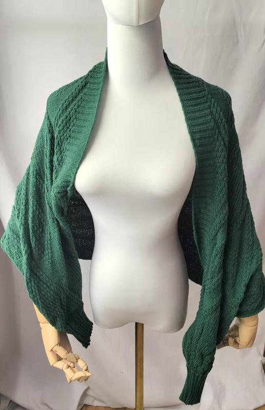 Green cable knit open front cocoon shrug cardigan with balloon sleeves displayed on a dress form mannequin - private label service available