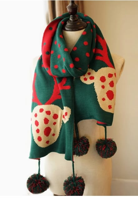 Green knitted holiday scarf with reindeer and red polka dot pattern, displayed on mannequin with decorative pom-pom fringe ends - bulk order 500+ pcs extra 8% off