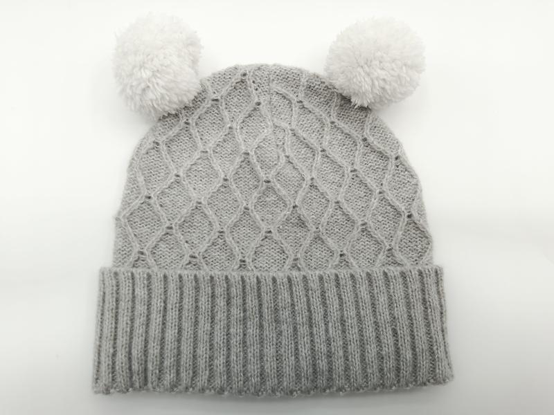 Grey cable knit baby winter beanie hat with two fluffy white pom poms and ribbed cuff, laid flat on white background - small batch 100pcs accepted