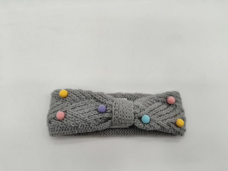 Grey knitted bow headband with multicolor pastel pom poms in yellow, pink, purple, teal on white background - ODM OEM service available