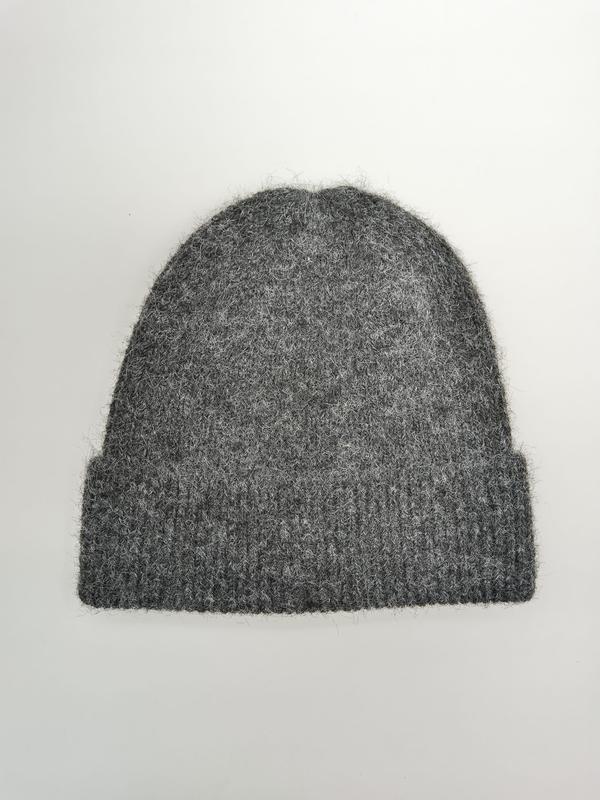 Grey fluffy knit beanie hat with ribbed cuff, laid flat on white background, soft wool blend winter hat - private label service available