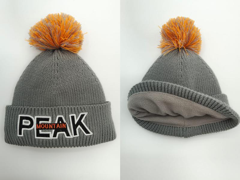 Grey chunky knit winter beanie with orange pom-pom, embroidered block letter patch, and soft fleece inner lining shown front and interior views - express production 15 days