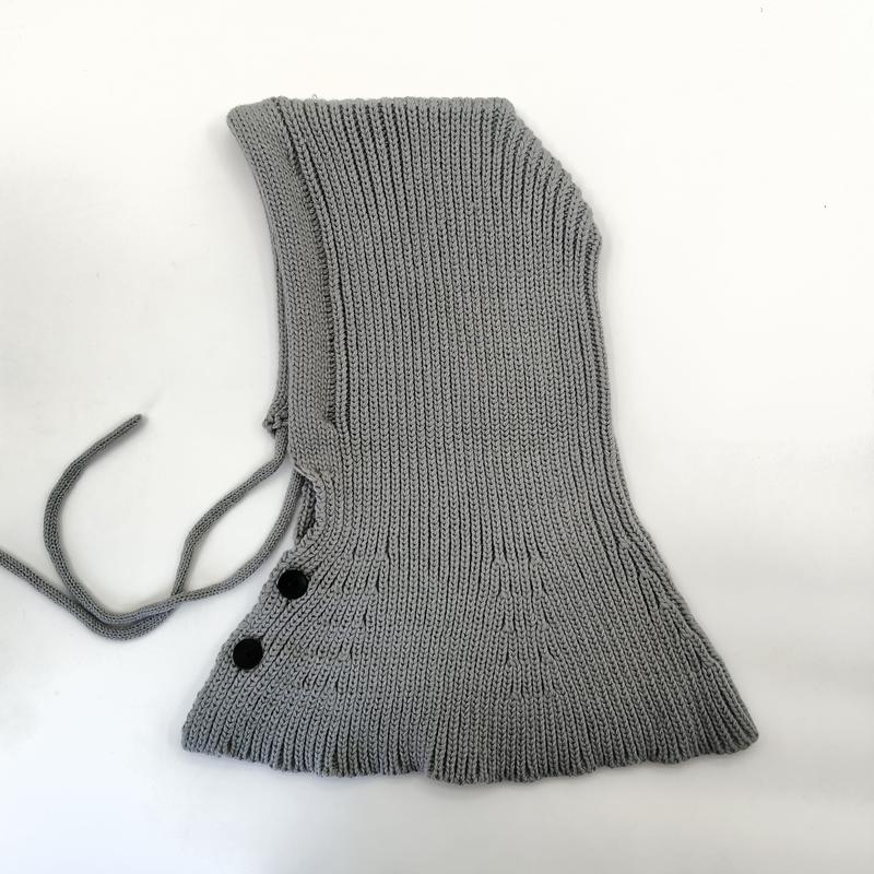 Grey ribbed knit balaclava hood with adjustable tie strings and two black button closures on white background - free sample within 7 days