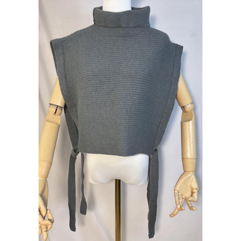 Grey ribbed knit sleeveless turtleneck sweater vest with side tie closures displayed on a wooden mannequin - wholesale price for USA buyers