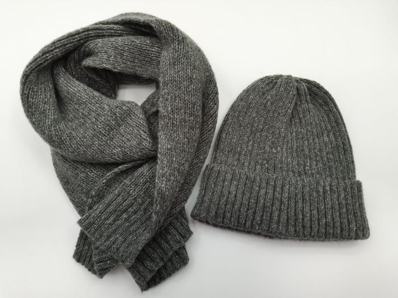 Heather grey ribbed knit beanie hat and matching long knit scarf set laid flat on white background - corporate gift customization