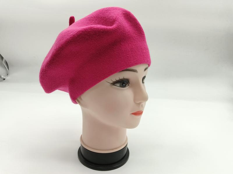 Hot pink wool knit French beret displayed on a female mannequin head, shown from a three-quarter side angle - event merchandise supplier