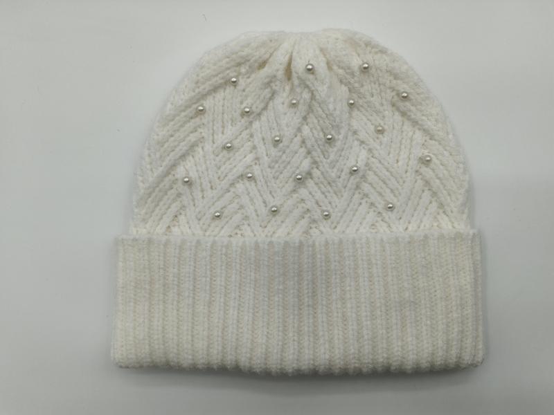 Cream white chunky knit beanie hat with zigzag chevron pattern and scattered pearl bead embellishments on grey background - certified scarf manufacturer China - jacquard custom pattern accepted