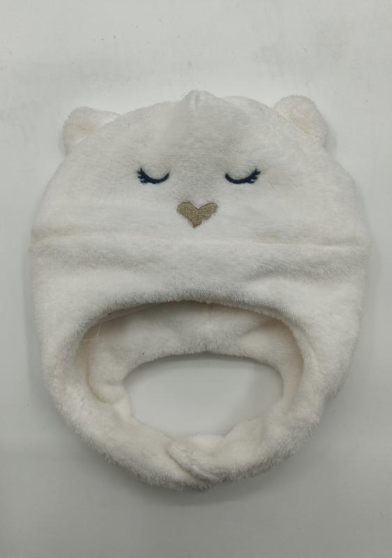 Soft white fleece infant hat shaped like a bear with embroidered closed eyes, gold heart nose, and small ears - corporate gift customization
