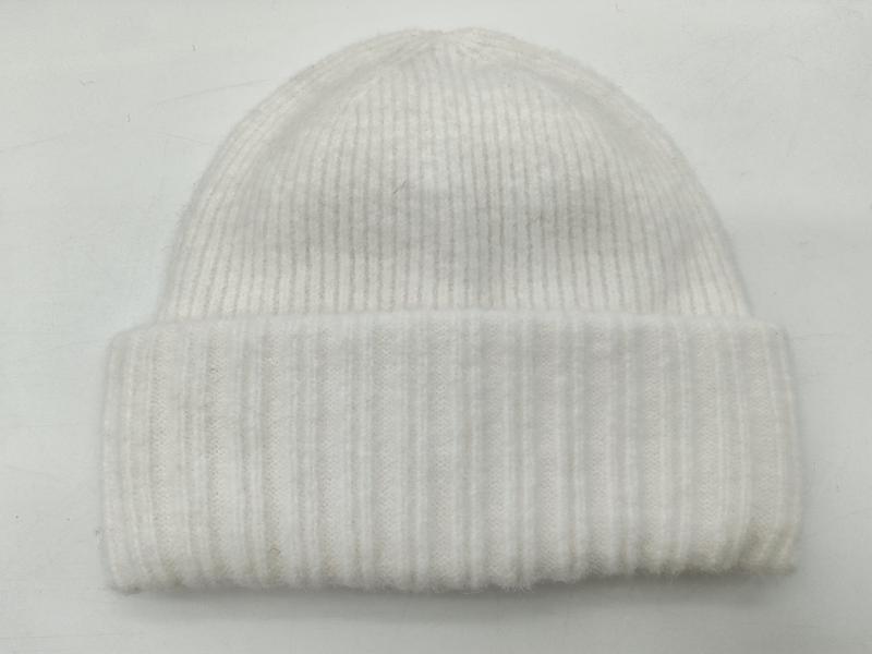 White ribbed knit winter beanie hat with folded cuff displayed flat on white background - factory direct price no middleman
