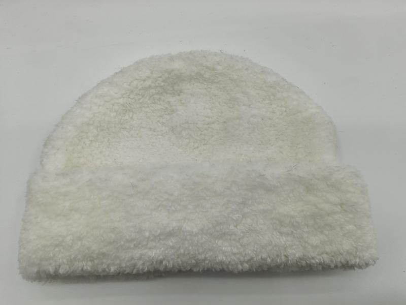 White cream sherpa fleece beanie hat with curly teddy texture, laid flat on white background, cozy winter accessory - Oeko-Tex Standard 100 certified