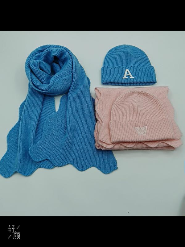 Blue knit scarf and beanie with letter A embroidery beside pink knit hat and scarf set with butterfly detail on white surface - sample order 10pcs available
