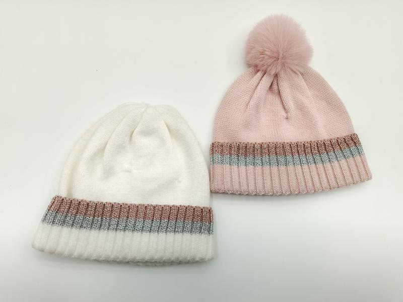 Two knit beanies in white and pink with rose gold and silver metallic stripe cuffs, pink hat has fur pom-pom on top - bulk order 500+ pcs extra 8% off