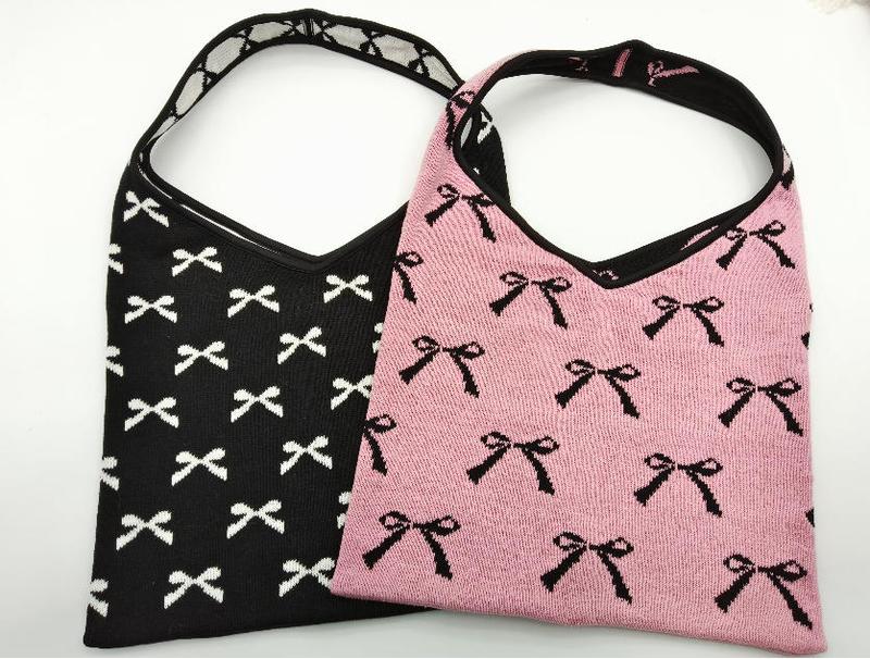 Two knit hobo bags with allover bow pattern, one black with white bows and one pink with black bows, shoulder straps - low MOQ 50pcs trial order