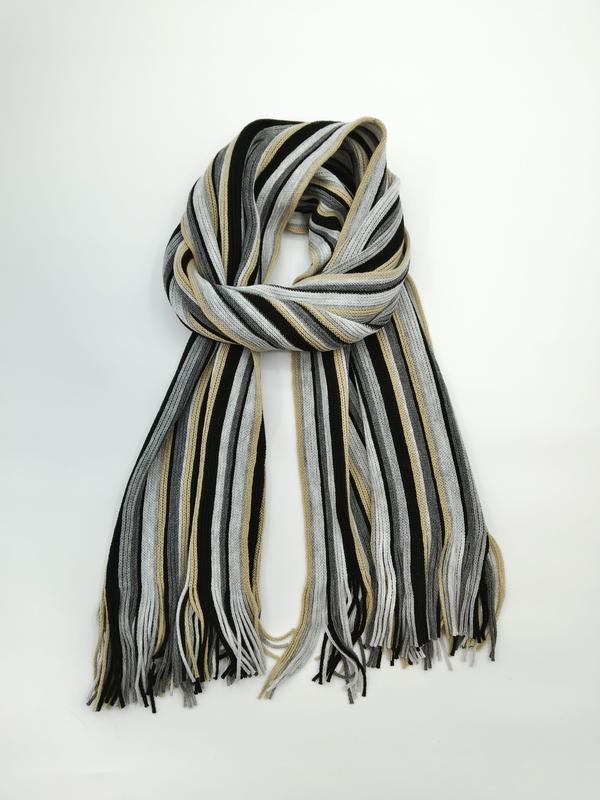Knitted striped scarf in black, grey, and beige tones with tassel fringe ends, loosely looped on white background - bulk order 500+ pcs extra 8% off