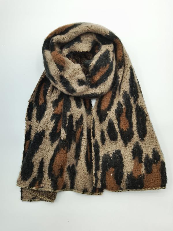 Coiled leopard print knit scarf in beige, brown, and black animal pattern, soft fluffy texture on white background - email us get price list now